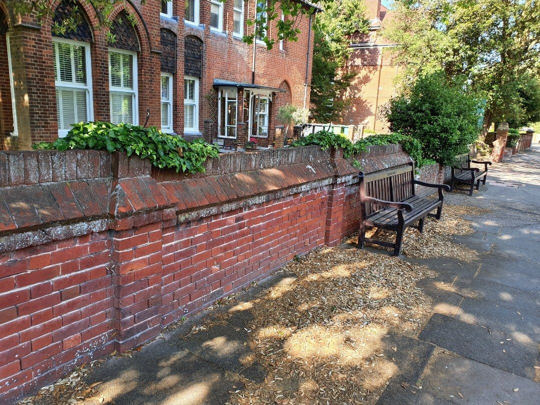 Repointed red-brick boundary wall along a street