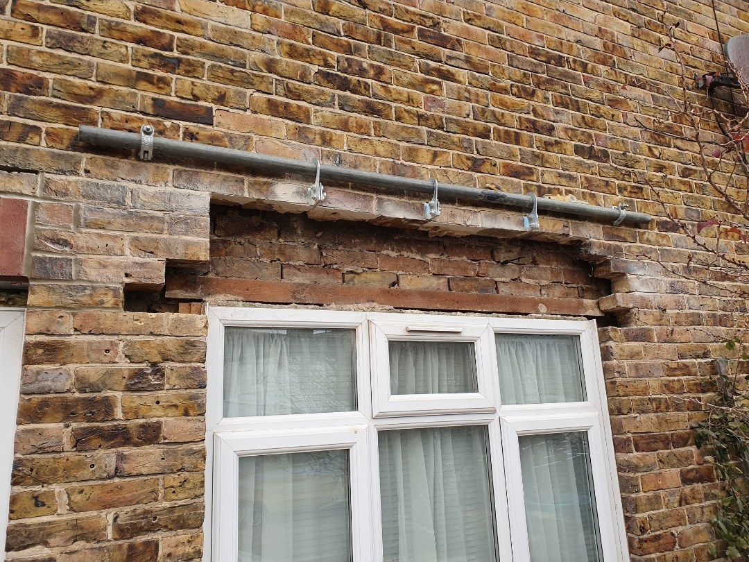 Yellow brick beside a window lintel, partway through
